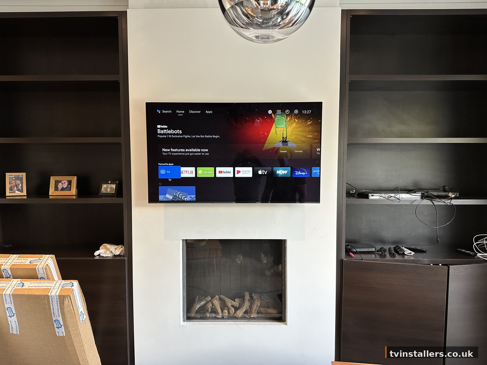 TV above fireplace with built-in shelving