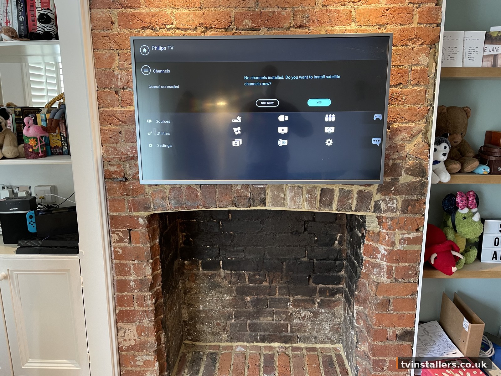TV above brick fireplace